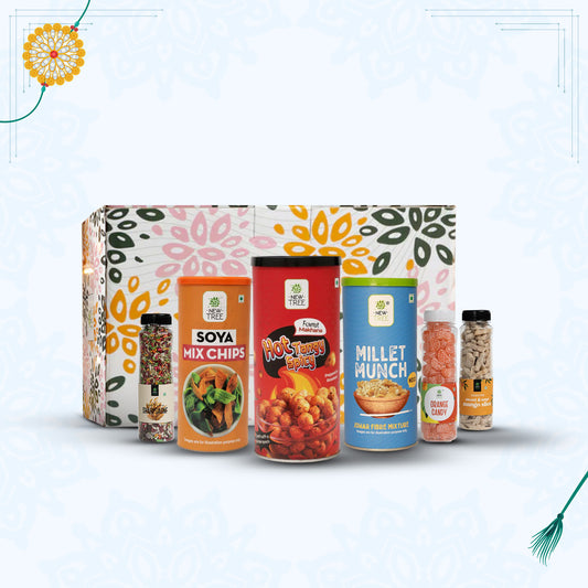 Assorted food products including Soya Mix Chips, Hot & Spicy Edamame, and Millet Munch in front of a decorative box.